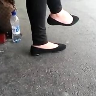 Beautiful feet in black flats 